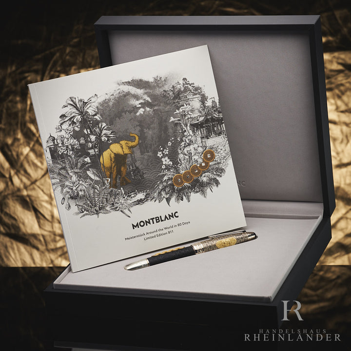Mehrfarbiger Füller mit aufwendigen Details liegt mit Editionsheft in geöffneter Originalbox vor goldenem Hintergrund