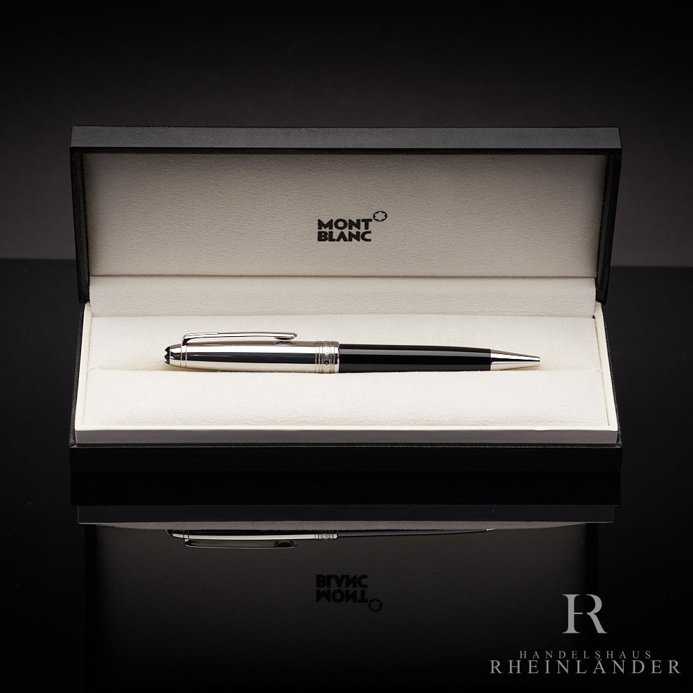 Schwarzer Kugelschreiber mit silberner Kappe in Originalbox liegend vor schwarzem Hintergrund
