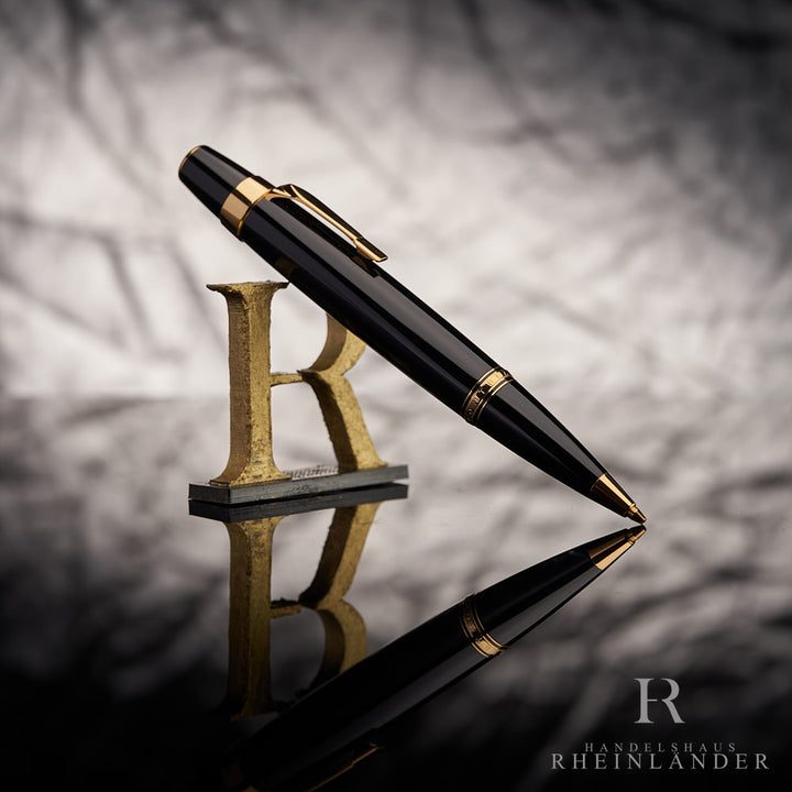 Schwarzer Montblanc Boheme Gold Line Drehbleistift mit goldenen Beschlägen vor silbernem Hintergrund