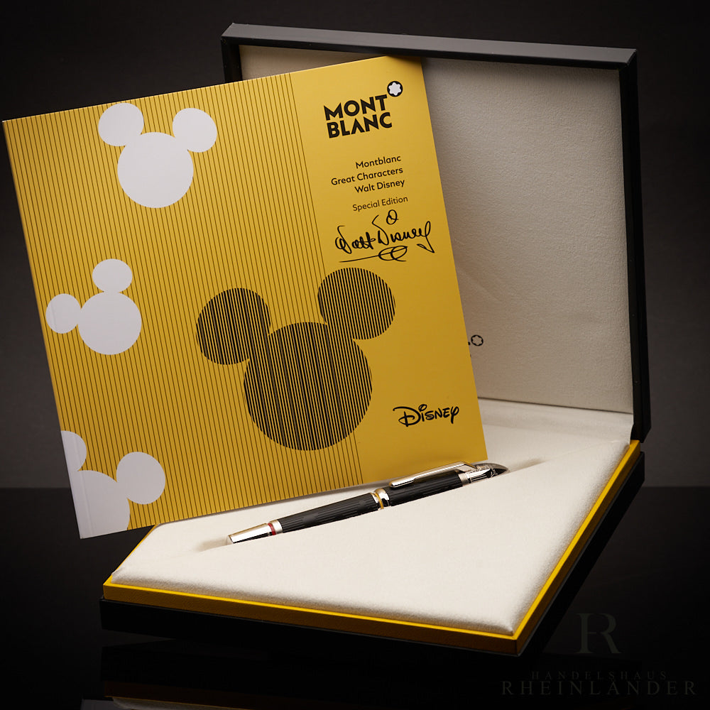 Schwarzer Rollerball liegt in offener Editionsbox. Darin aufgestellt das gelbe Disney-Serviceheft