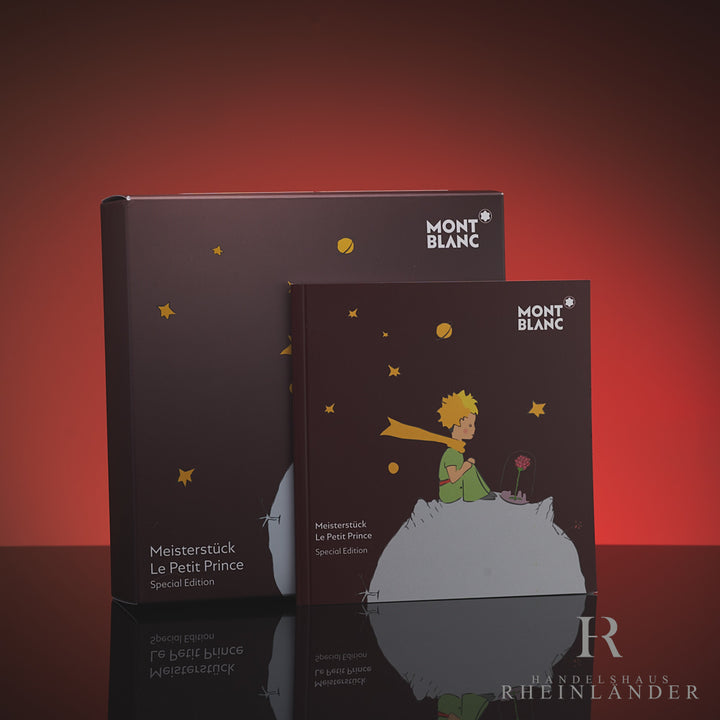 Burgundfarbenes Service Heft vor dazugehöriger Montblanc Petit Prince Umverpackung mit Aufdruck des kleinen Prinzen