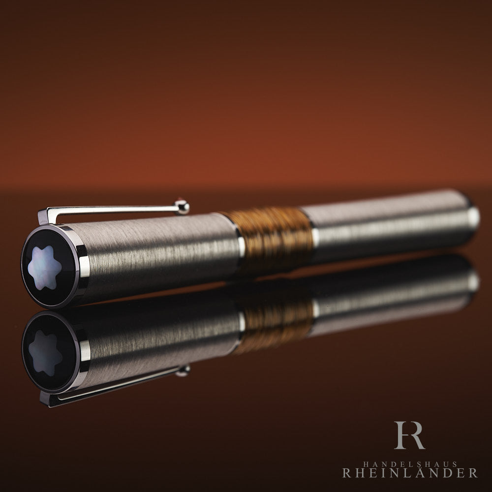 Kappenkopf mit Perlmutt Emblem des Gandhi Limited Edition 241 Füllers von Montblanc liegend vor braunem Hintergrund