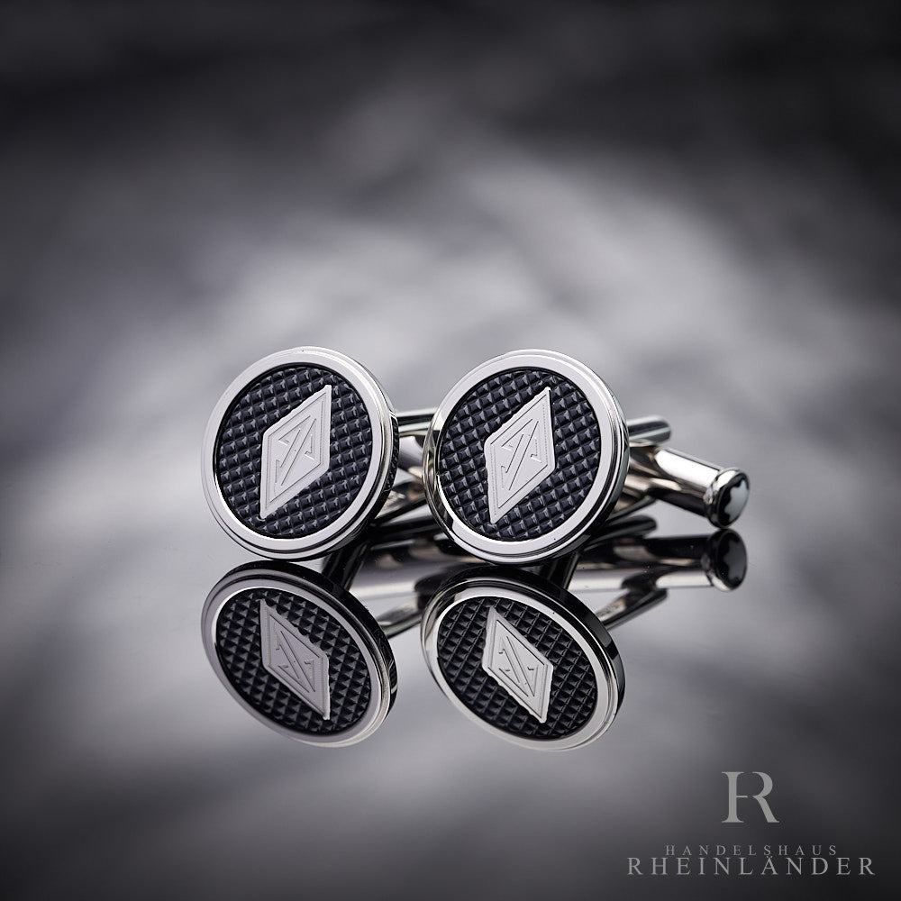 Montblanc Great Gatsby Manschettenknöpfe mit Logo und schwarzem Inlay vor silbernem Hintergrund