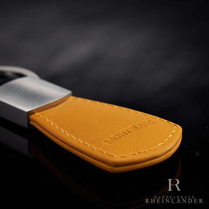 Nahaufnahme der Montblanc-Prägung auf der Rückseite des Schlüsselrings auf schwarzem Tisch