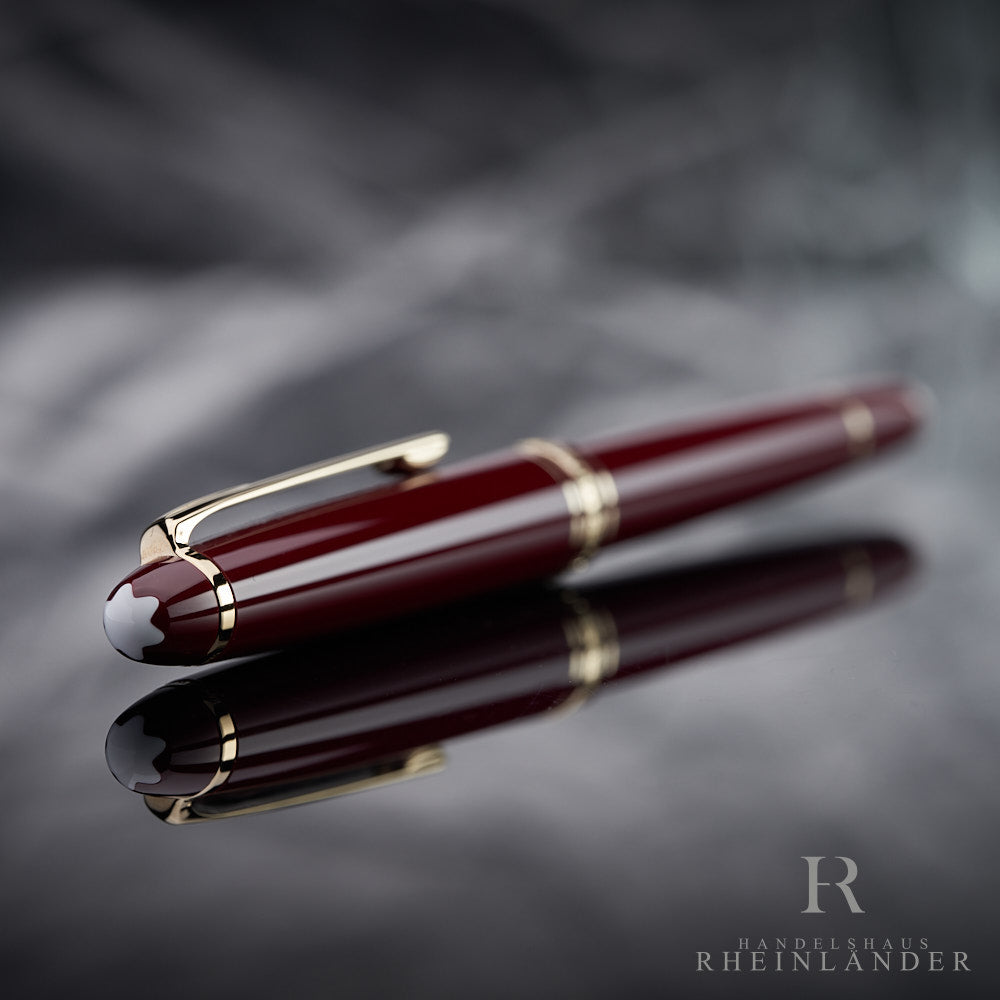 Montblanc Classique Burgundy Rollerball liegend mit Kappe und Emblem voran