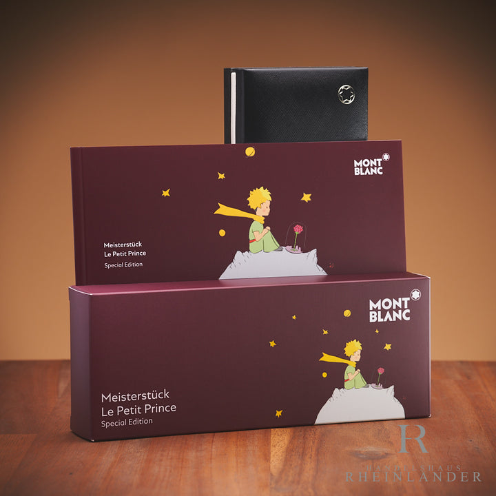 Originalverpackung, Service Guide und Umverpackung der Montblanc Petit Prince  & Planet Kollektion vor braunem Hintergrund