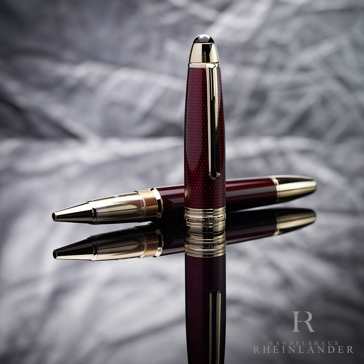 Montblanc Golden Hour Rollerball liegend mit daneben stehender Kappe vor silbernem Hintergrund